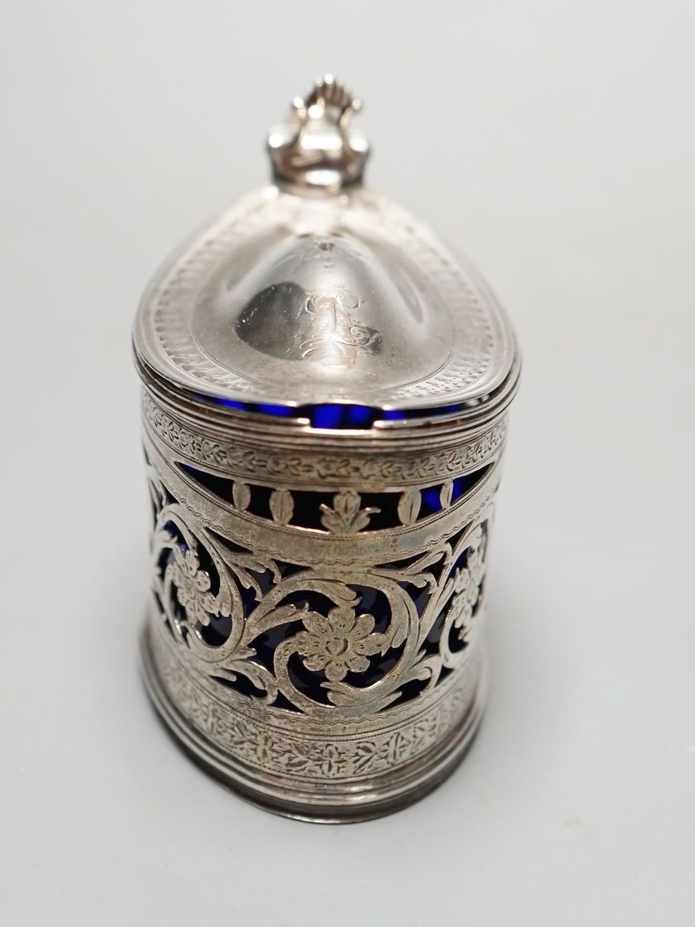 A George III engraved and pierced silver oval mustard pot, Michael Plummer, London, 1793, length 10cm.